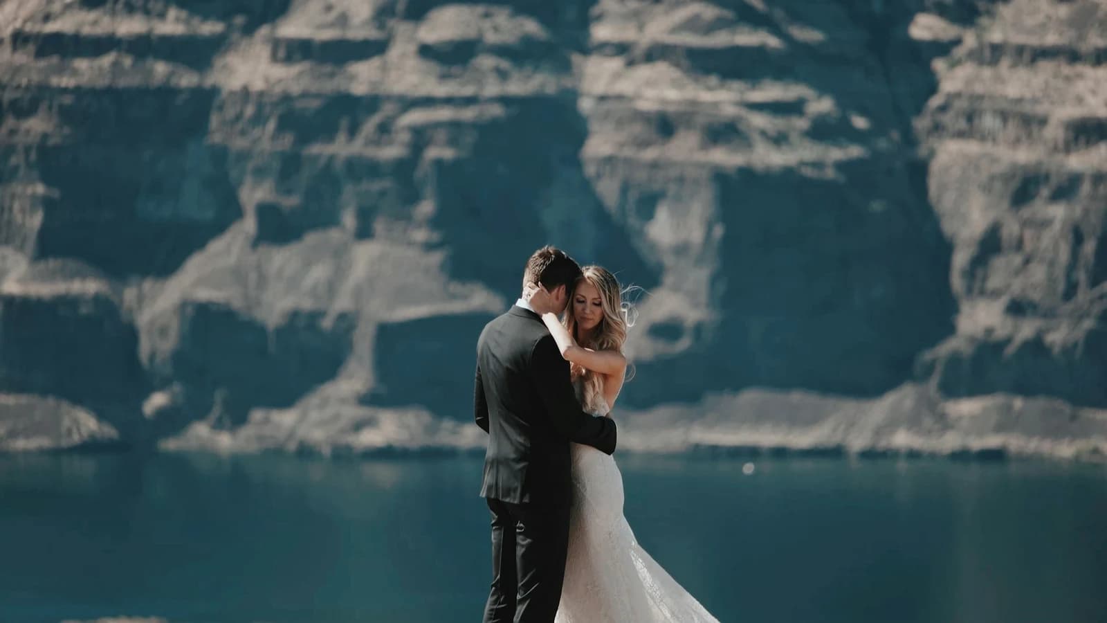 Dolomites Adventure & Intimate Elopement Elopement couple embracing beside a turquoise alpine lake in the Dolomites