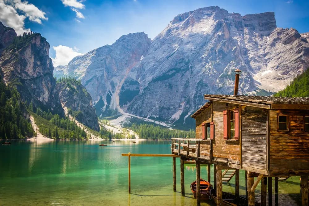Micro Wedding at Lago di Braies: Planning a Small Ceremony Lago di Braies: wooden boathouse on the turquoise lake with the Dolomites rising behind