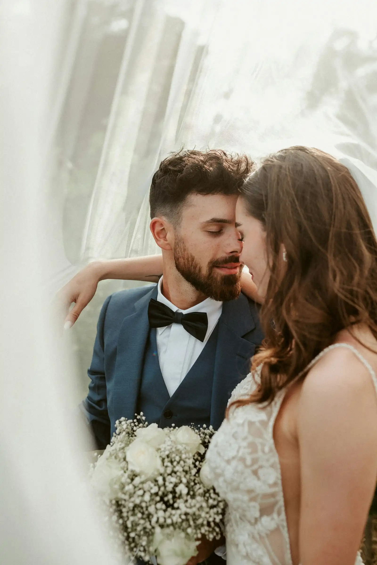 How to Plan a Surprise Proposal in the Dolomites: Top Secret Locations Newly engaged couple in a close embrace, the bride holding a white bouquet