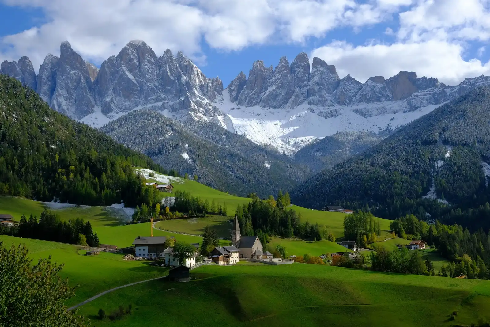 Val di Funes Wedding Photography: The Complete Guide to St. Magdalena Val di Funes: village church and farmhouses in a green valley beneath the Odle peaks